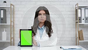 Doctor Woman Showing Digital Tablet With Green Screen In Office