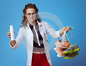 Doctor woman showing fit sneakers and shoe deodorizer spray