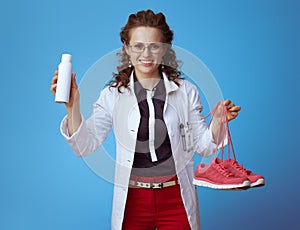 Doctor woman showing fitness sneakers and shoe deodorizer spray