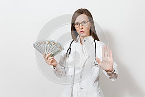 Doctor woman showing stop gesture with palm isolated on white background. Female doctor in medical gown with stethoscope