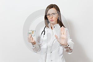 Doctor woman showing stop gesture with palm isolated on white background. Female doctor in medical gown with stethoscope