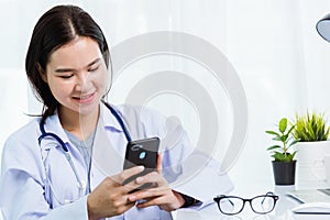 Doctor woman smiling using working with smart mobile phone