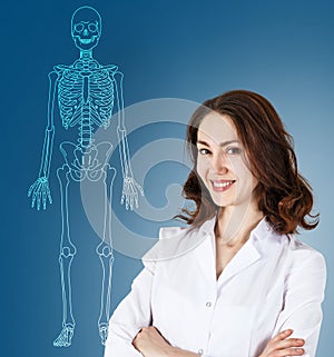 Doctor woman standing near drawing human skeleton