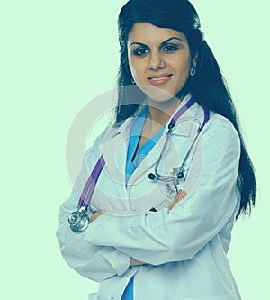 Doctor woman with stethoscope standing near wall
