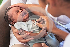 doctor woman using a stethoscope, checking the respiratory system and heartbeat Of a 1-month-old baby newborn