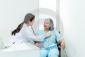 Doctor woman Using a stethoscope Listen to heart rate of elderly woman