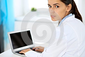 Doctor woman warking with laptop in office