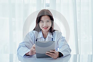 Doctor woman wearing stethoscope working with laptop computer on clinic