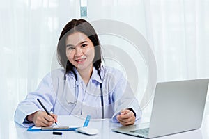 Doctor woman writing something on paperwork or clipboard white paper