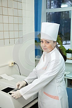 Doctor working with Biochemistry Analyzer