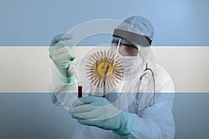 Doctor working with blood samples in hospital clinic lab. Transparent flag of Argentina over the photo