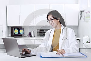 Doctor working in the clinic with laptop