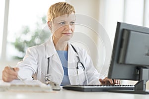 Doctor Working On Computer At Desk