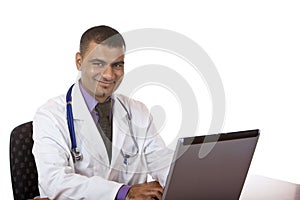 Doctor is working on computer laptop in office