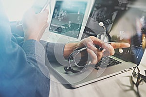 Doctor working with digital tablet and laptop computer with smart phone in medical workspace office and video conferance as