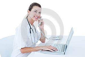 Doctor working on her laptop and calling