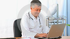 Doctor working on his laptop