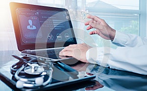 doctor working on a laptop computer for health records in the medical office.The concept is checking and taking care of