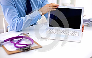 Doctor working with laptop computer in medical