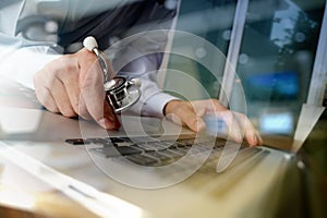 Doctor working with laptop computer in medical workspace office