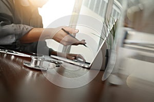 Doctor working with laptop computer in medical workspace office