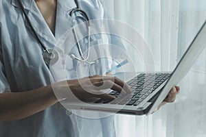 Doctor working with laptop computer in medical workspace office. doctor working on laptop computer in modern clinics office.