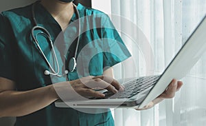 Doctor working with laptop computer in medical workspace office. doctor working on laptop computer in modern clinics office.