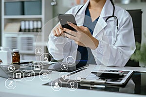 Doctor working on laptop computer and tablet and medical stethoscope on clipboard on desk, electronics medical record system EMRs