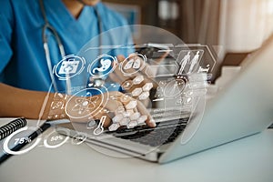 Doctor working on laptop computer and tablet and medical stethoscope on clipboard on desk