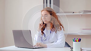 Doctor working with medical records on computer