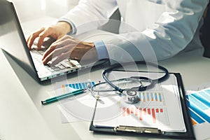 doctor working with medical statistics and financial reports