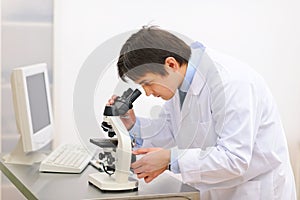 Doctor working with microscope in laboratory