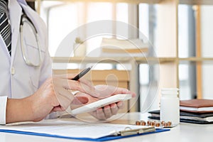 Doctor working at office desk with modern medical healthcare concept, Hospital background