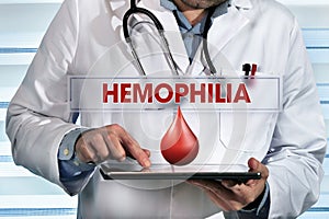 doctor working with tablet in hands in the lab with message hemophilia photo