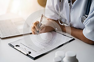 Doctor working to write a patient report in the clinic