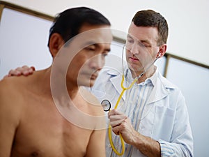 Doctor working and visiting old man in clinic