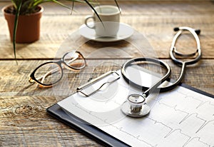 Doctor workplace with a stethoscope at wooden table