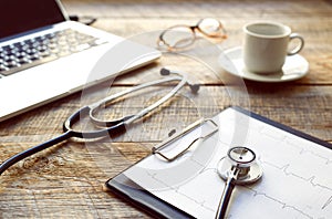 Doctor workplace with a stethoscope at wooden table