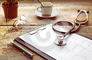 Doctor workplace with a stethoscope at wooden table