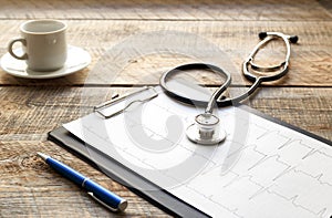 Doctor workplace with a stethoscope at wooden table