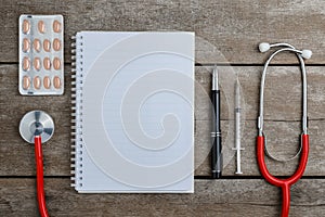 Doctor workplace with a stethoscope on wooden table