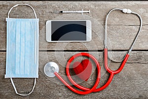 Doctor workplace with a stethoscope on wooden table