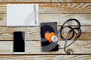 Doctor workplace with tablet and stethoscope