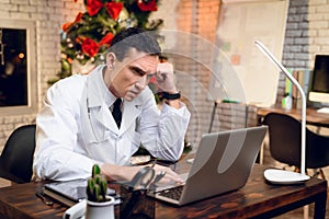 The doctor works on New Year`s Eve. He`s in the office and he`s bored.