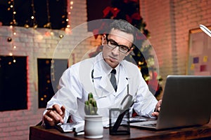 The doctor works on New Year`s Eve. He is very tired but continues to work.