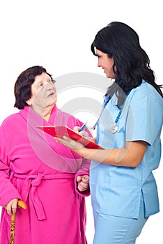 Doctor write prescription to elder woman