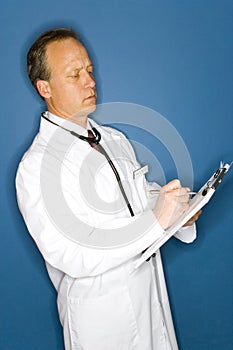 Doctor writing on chart