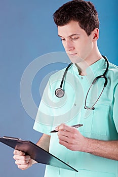 Doctor writing on a clip board