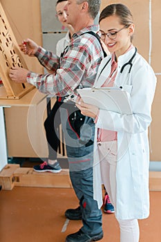 Doctor writing down results from occupational therapy dexterity test photo