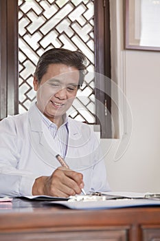 Doctor Writing at His Desk